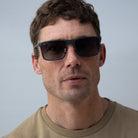 Man wearing metal rectangle sunglasses