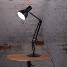 Sleek Jet Black Anglepoise Type 75 Desk Lamp. Close-up shot showcasing durable head, arm, and stable base. Perfect for any workspace.