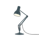 Sleek Anglepoise Type 75™ Slate Grey Desk Lamp with adjustable metal arm, bright white bulb, and durable weighted base. Ideal for workspaces.